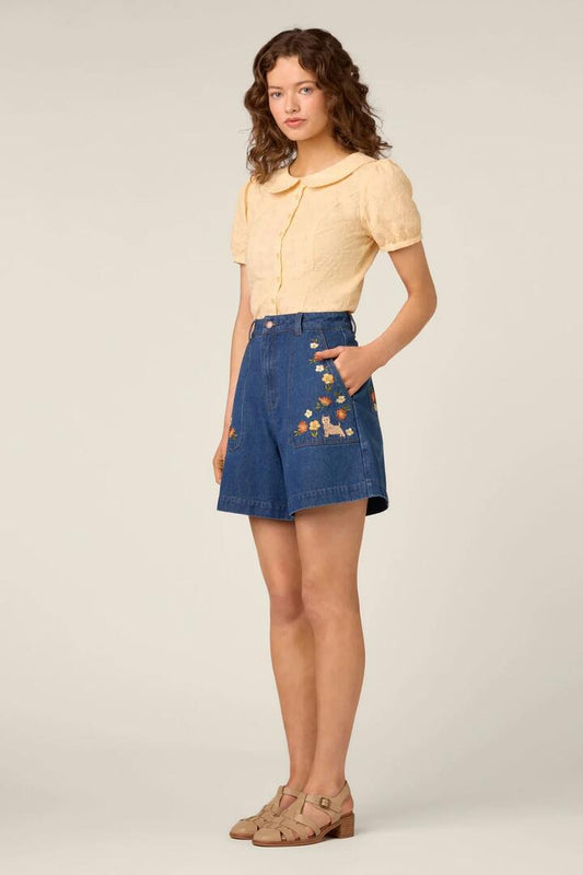 Image of a model wearing Shorts. Product name - Sweet Dogs Embroidered Shorts in Blue Denim colour by brand - Princess Highway