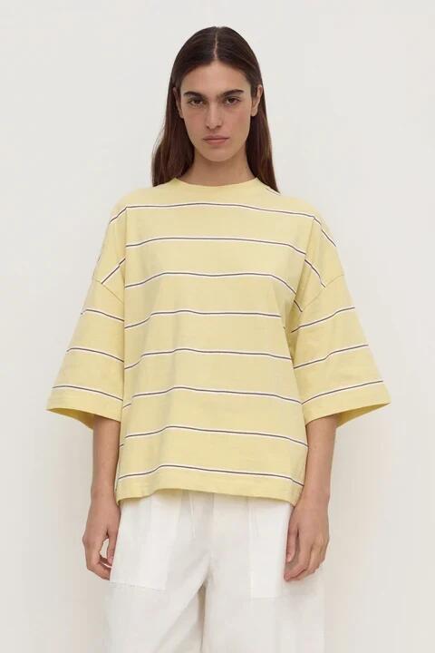 Image of a model wearing Tops. Product name - Nora Rind Butter Cotton Stripe Oversized Tee SS Stripe in Yellow colour by brand - Assembly Label