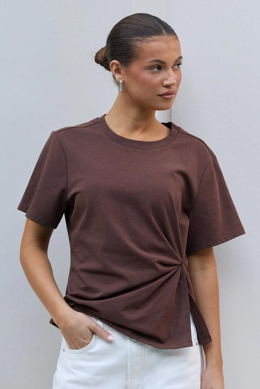 Image of a model wearing Tops. Product name - Rupture Chocolate Split Detail Tee in Chocolate colour by brand - Ivy + Jack
