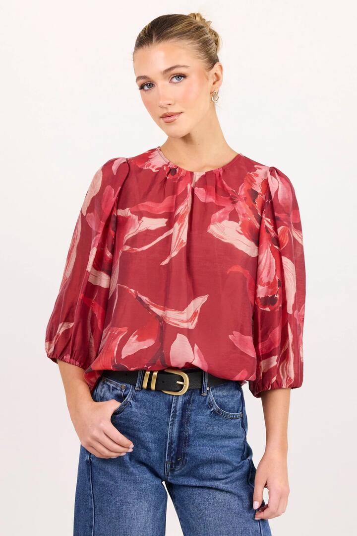 Image of a model wearing Tops. Product name - Sincere Large Red Peony Shirred Back SS Top in Large Red Peony colour by brand - Ivy + Jack