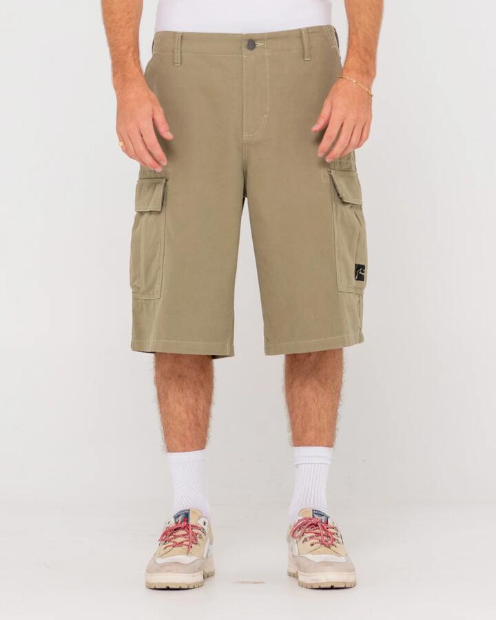 Image of a model wearing Shorts. Product name - Rusty Mens Commando Cargo Shorts Savanna in Savanna colour by brand - Rusty