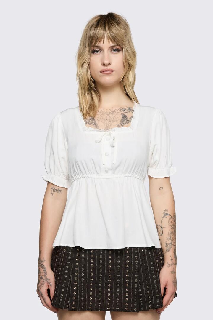 Image of a model wearing Tops. Product name - Low Whisper Flowy Top in Cream colour by brand - Black Friday