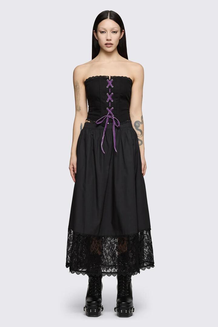 Image of a model wearing Skirts. Product name - Spectre Midi Skirt in Black colour by brand - Dangerfield