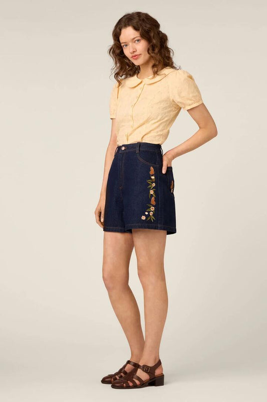 Image of a model wearing Shorts. Product name - Butterfly Embroidered Short in Dark Denim colour by brand - Princess Highway