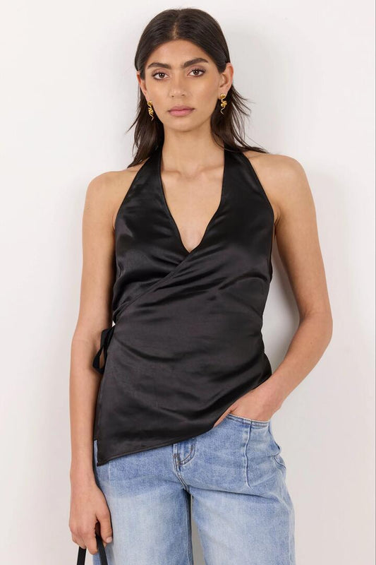 Image of a model wearing Tops. Product name - Replete Black Satin Halter Neck Wrap Front Top in Black colour by brand - Georgia Zoe