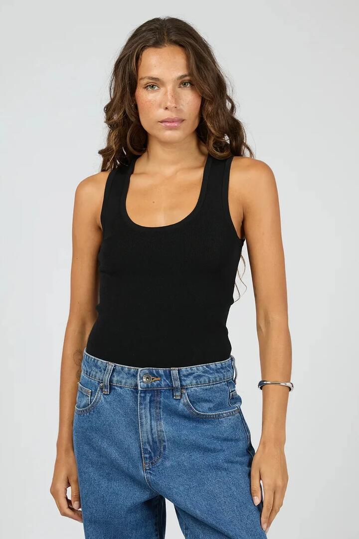 Image of a model wearing Tops. Product name - Ollie Black Scoop Rib Knit Tank in Black colour by brand - Silent Theory