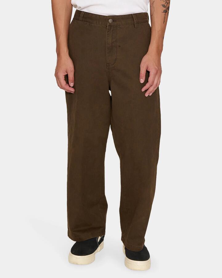 Image of a model wearing Pants. Product name - Thrills Stagger Big Slacker Cropped Pant Cmg3 Postal Brown in Postal Brown colour by brand - Thrills