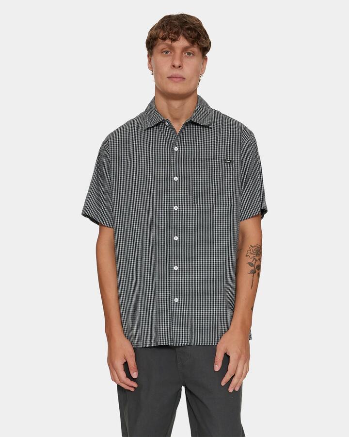 Image of a model wearing Tops. Product name - Thrills Split Decision Short Sleeve Check S P62 Petrol in Petrol colour by brand - Thrills