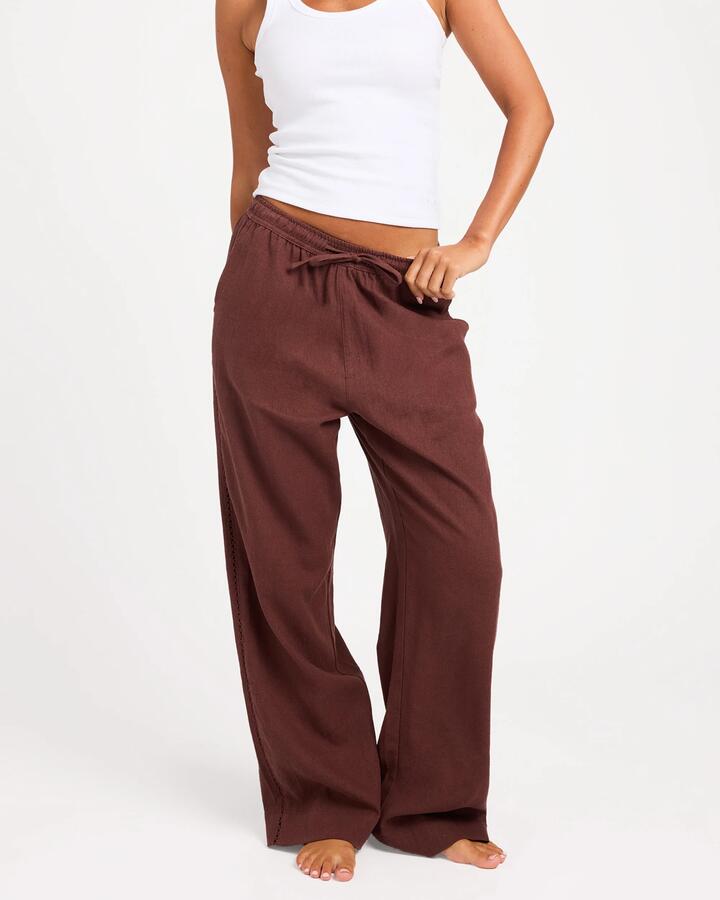 Image of a model wearing Pants. Product name - Roxy Womens Sun Lover Elastic Waist Pants Java in Java colour by brand - Roxy