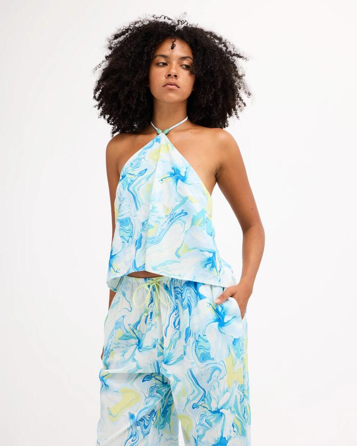 Image of a model wearing Tops. Product name - Billabong Womens Island Calling Halter Top Cool Blue in Cool Blue colour by brand - Billabong
