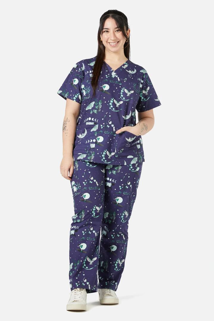 Image of a model wearing Uniforms & Workwear. Product name - Nocturnal Scrub Set in Navy colour by brand - Scrubs With Love