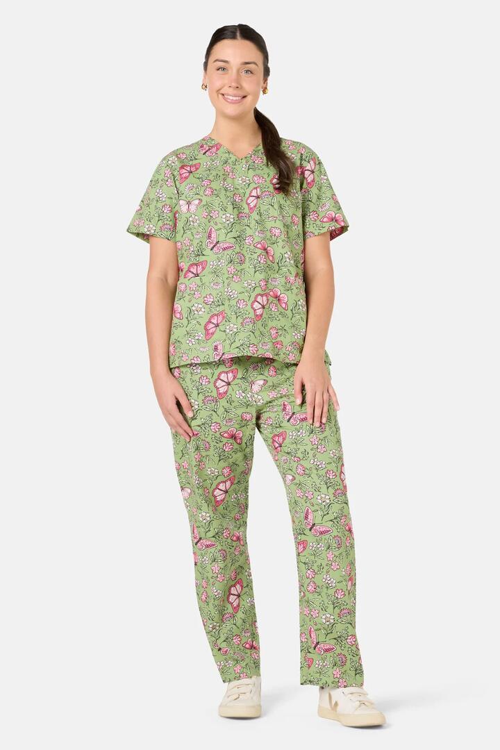 Image of a model wearing Uniforms & Workwear. Product name - Yvette Butterfly Scrub Set in Green colour by brand - Scrubs With Love