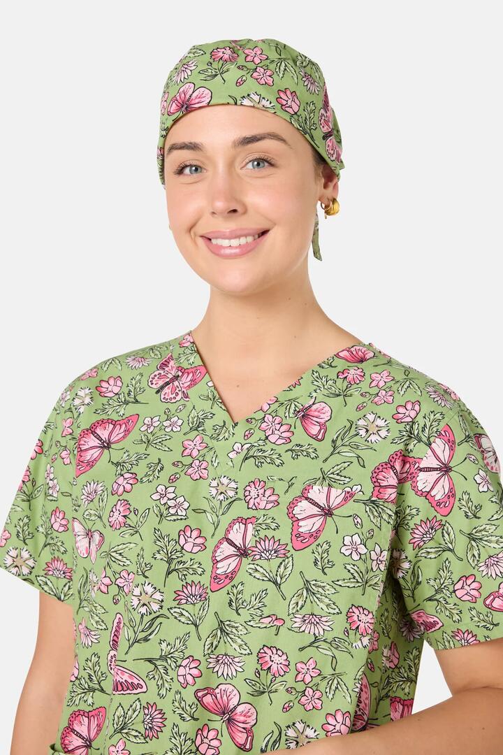 Image of a model wearing Uniforms & Workwear. Product name - Yvette Butterfly Scrub Hat in Green colour by brand - Scrubs With Love