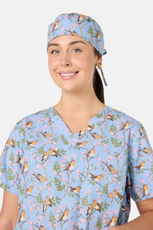 Image of a model wearing Uniforms & Workwear. Product name - Robin Scrub Hat in Light Blue colour by brand - Scrubs With Love