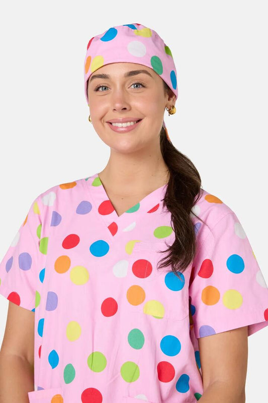 Image of a model wearing Uniforms & Workwear. Product name - Confetti Scrub Hat in Pink colour by brand - Scrubs With Love