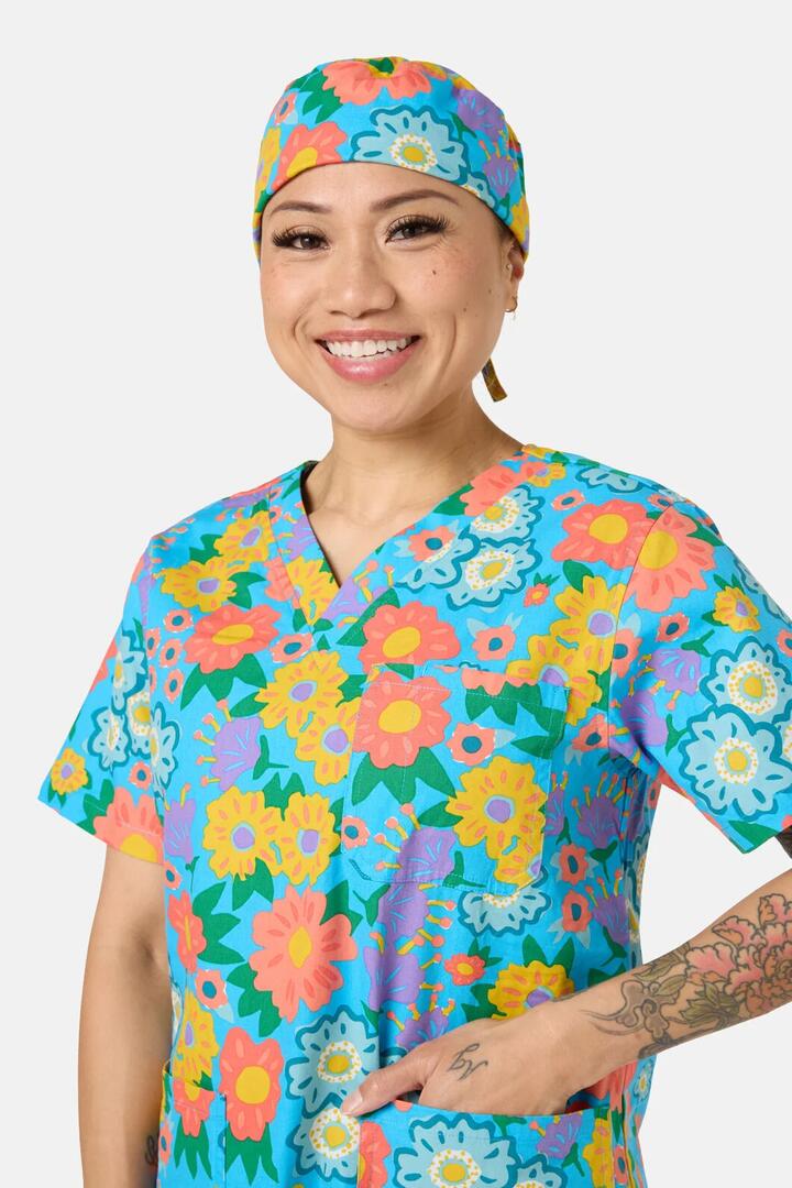 Image of a model wearing Uniforms & Workwear. Product name - Painted Garden Scrub Hat in Aqua colour by brand - Gorman