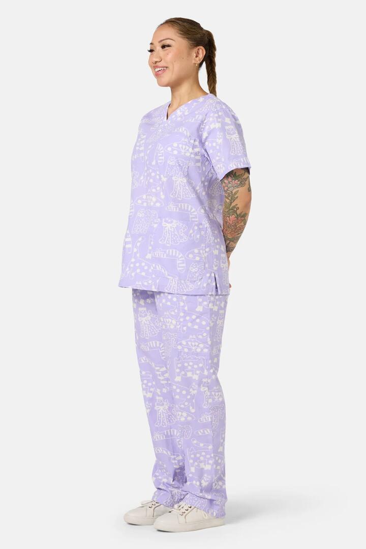 Image of a model wearing Uniforms & Workwear. Product name - Lilac Cat Scrub Set in Lilac colour by brand - Gorman