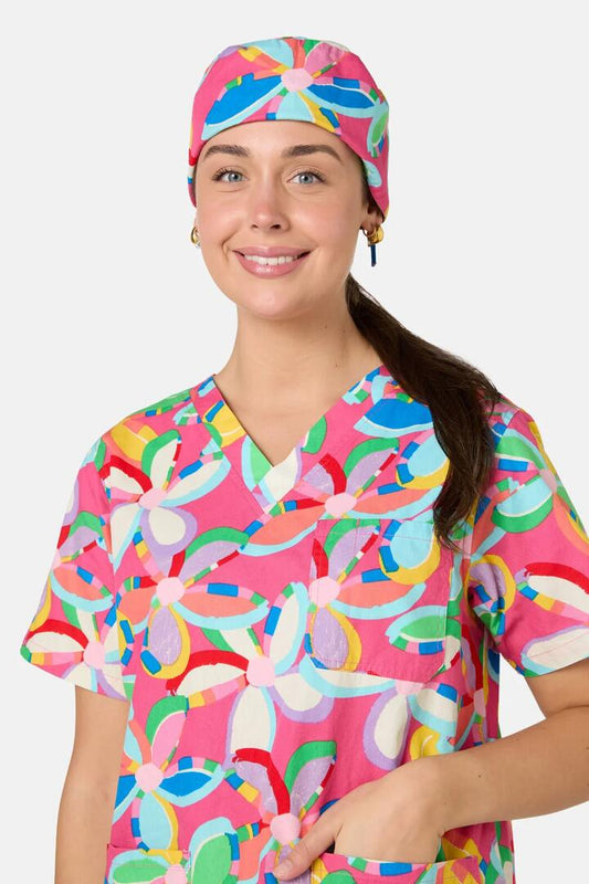 Image of a model wearing Uniforms & Workwear. Product name - Rainbow Daisy Scrub Hat in Multi colour by brand - Gorman