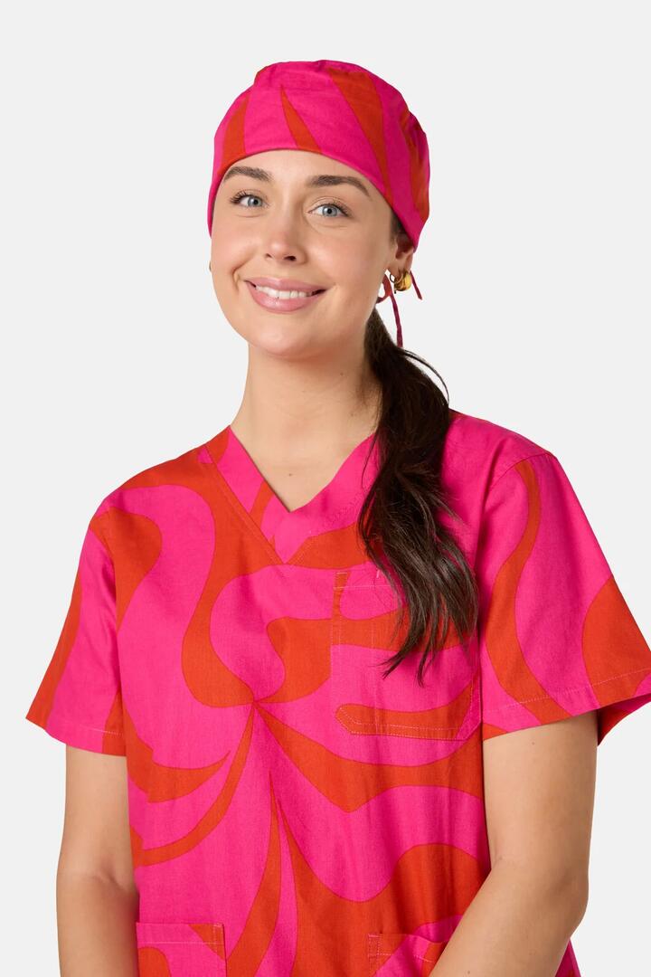 Image of a model wearing Uniforms & Workwear. Product name - Wavelength Scrub Hat in Pink colour by brand - Gorman