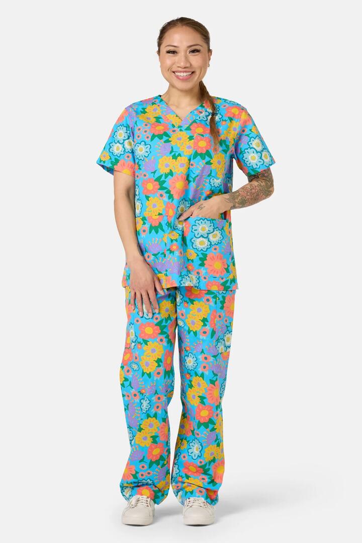 Image of a model wearing Uniforms & Workwear. Product name - Painted Garden Scrub Set in Aqua colour by brand - Gorman