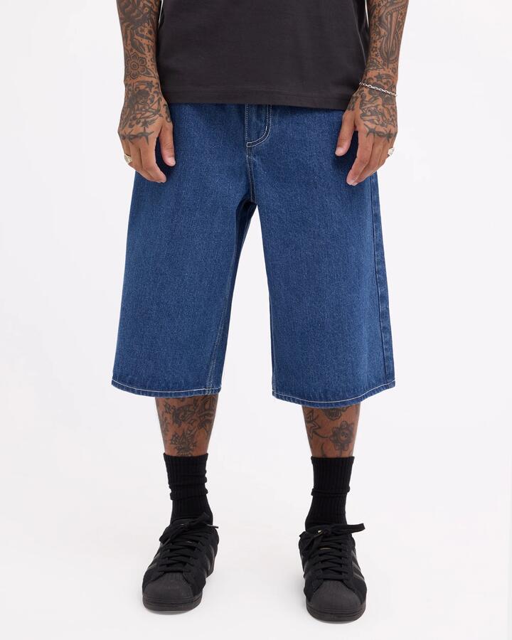 Image of a model wearing Shorts. Product name - Rvca Mens Dayshift Baggy 23.5" Denim Shorts Blue Collar in Blue Collar colour by brand - Rvca