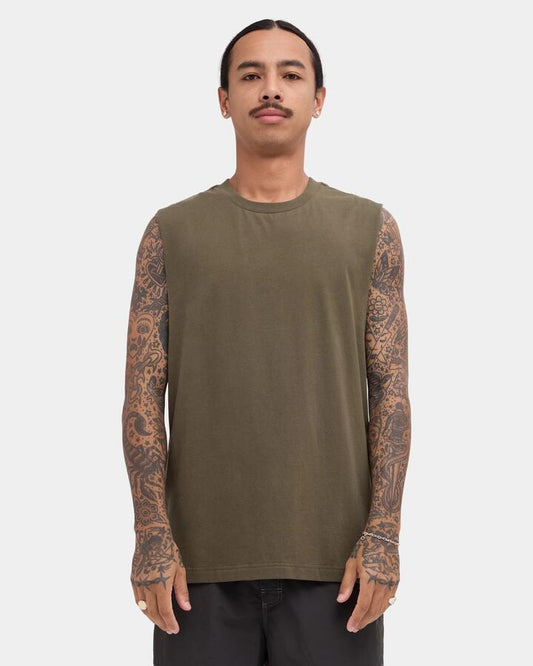 Image of a model wearing Tops. Product name - RVCA Mens Rvca Standard Muscle Fatigue in Fatigue colour by brand - RVCA