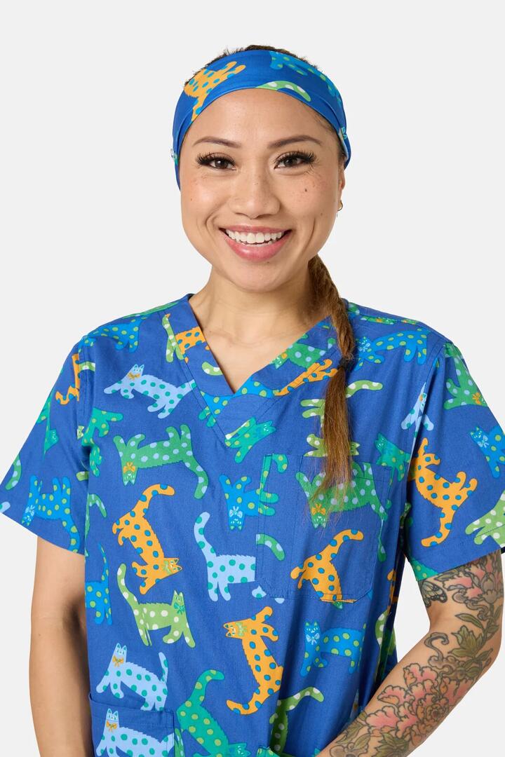 Image of a model wearing Uniforms & Workwear. Product name - Spotty Cats Scrub Headband in Navy colour by brand - Gorman