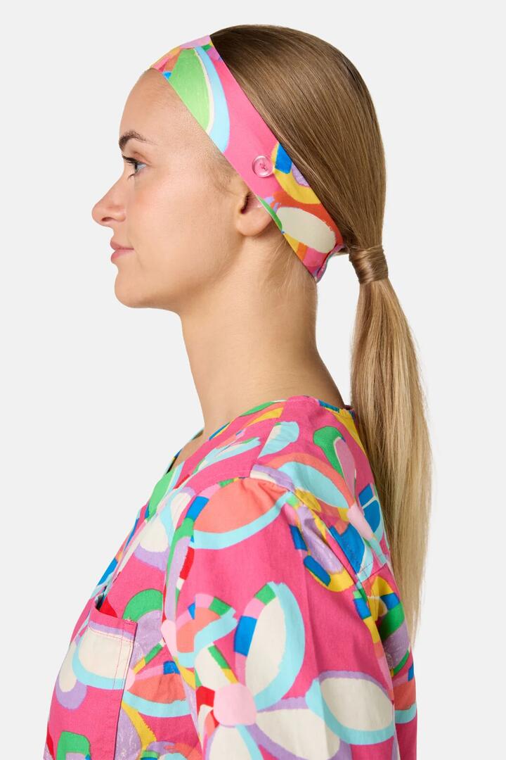 Image of a model wearing Uniforms & Workwear. Product name - Rainbow Daisy Scrub Headband in Multi colour by brand - Gorman