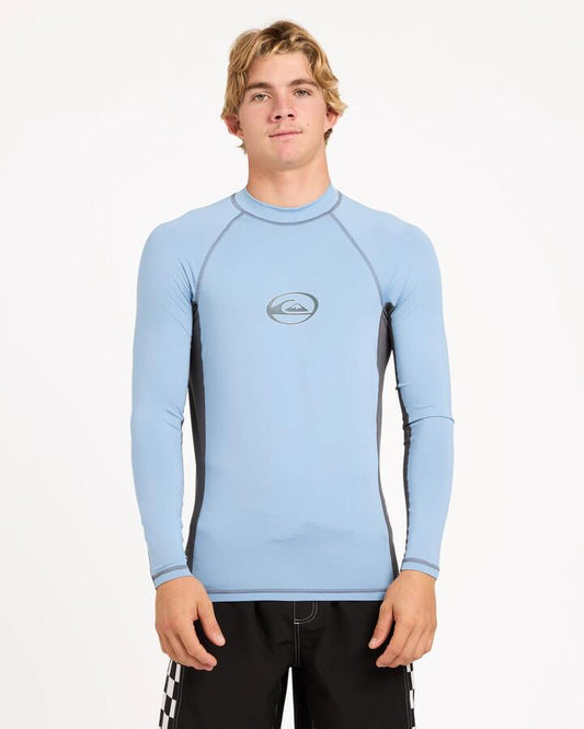 Image of a model wearing Tops. Product name - Quiksilver Mens Core Long Sleeve Surf Shirt Faded Denim in Faded Denim colour by brand - Quiksilver