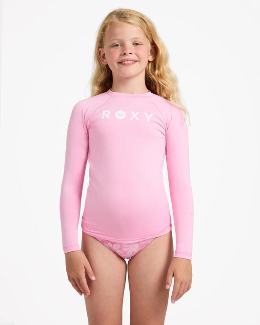 Image of a model wearing Tops. Product name - Roxy Girls 8-16 Essential Upf 50 Long Sleeve Rashguard M Pink in M Pink colour by brand - Roxy