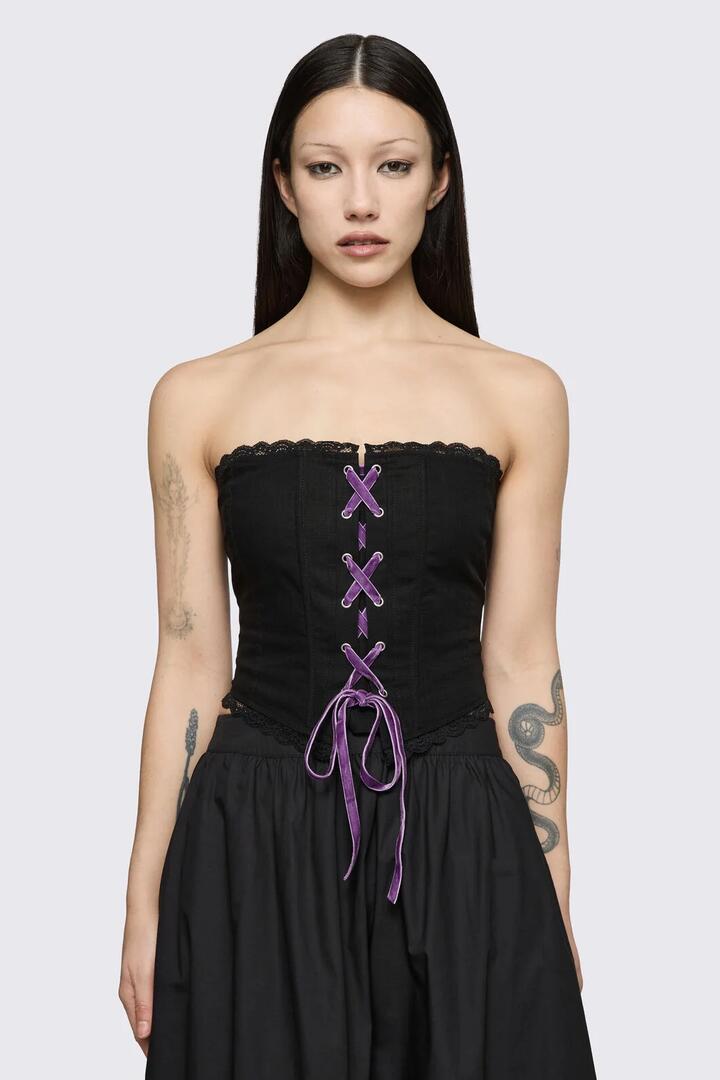 Image of a model wearing Tops. Product name - Spectre Corset Top in Black colour by brand - Dangerfield