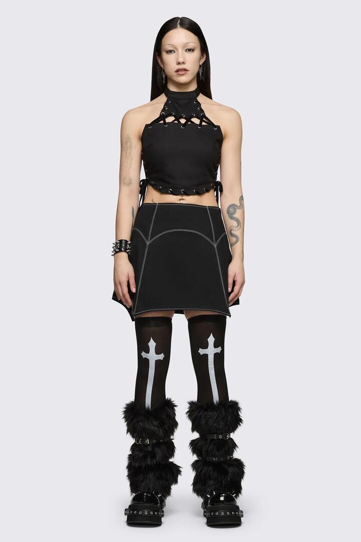 Image of a model wearing Tops. Product name - Ascend Halter Top in Black colour by brand - Black Friday