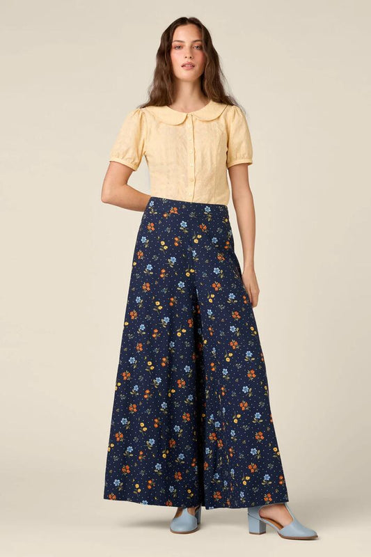 Image of a model wearing Pants. Product name - Chloe Ditsy 90's Wide Leg Pant in Navy colour by brand - Princess Highway