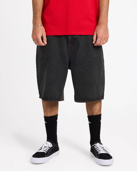 Image of a model wearing Shorts. Product name - Quiksilver Mens Shifter 23" Denim Shorts Black Black Dirty in Black Black Dirty colour by brand - Quiksilver