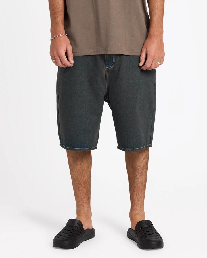 Image of a model wearing Shorts. Product name - Quiksilver Mens Shifter 23" Denim Shorts Medium Blue in Medium Blue colour by brand - Quiksilver