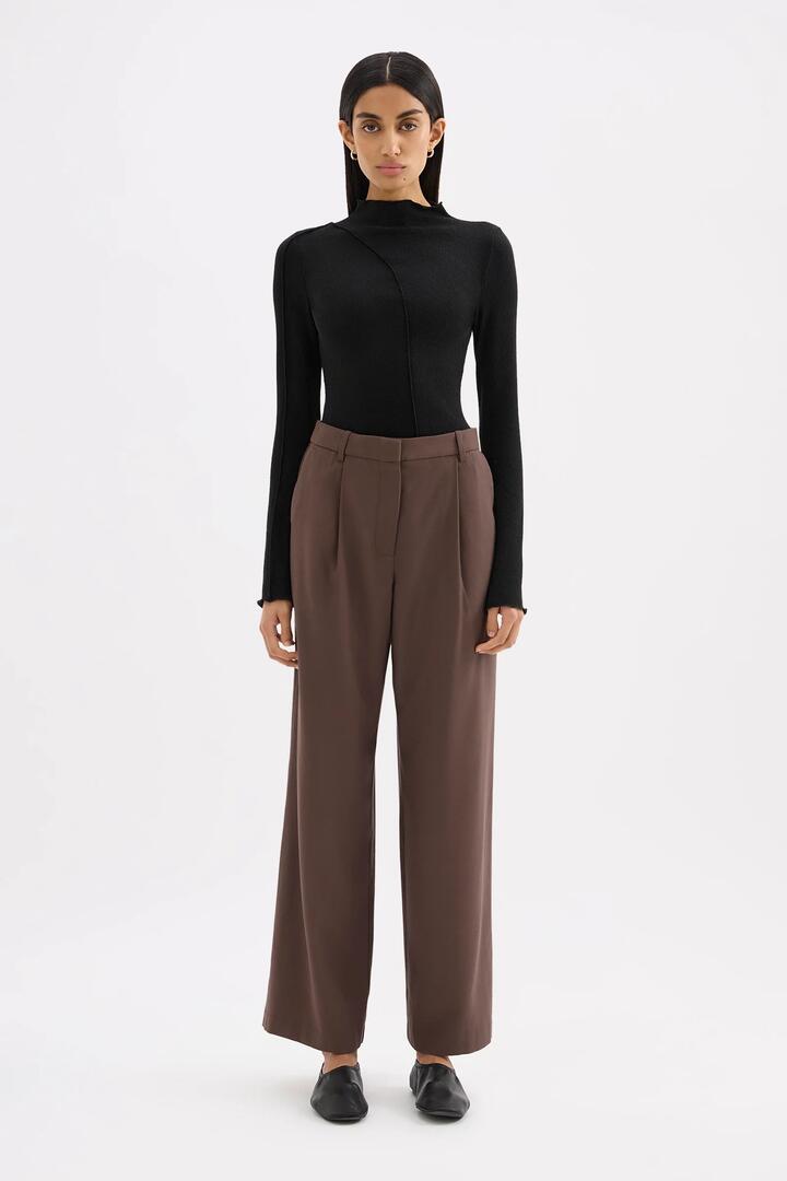 Image of a model wearing Pants. Product name - Nadia Chocolate Tailored Pant in Brown colour by brand - Nude Lucy
