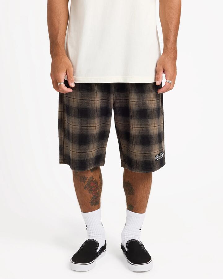 Image of a model wearing Shorts. Product name - Volcom Mens Freazy 22" Elastic Waist Shorts Earth in Earth colour by brand - Volcom