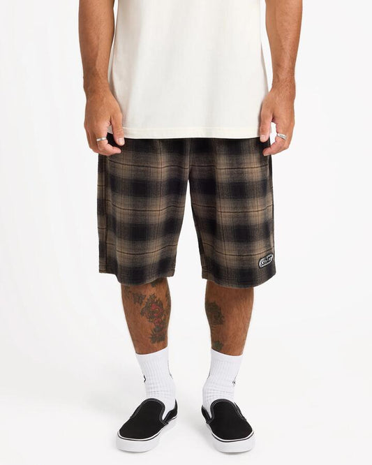Image of a model wearing Shorts. Product name - Volcom Mens Freazy 22" Elastic Waist Shorts Earth in Earth colour by brand - Volcom