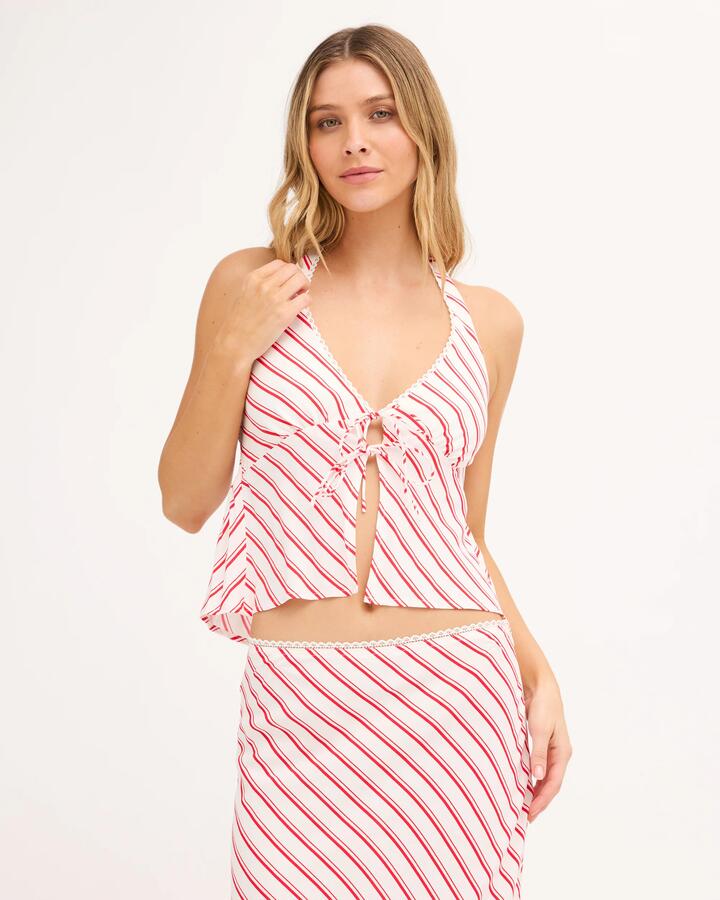 Image of a model wearing Tops. Product name - Billabong Womens Let It Shine Halter Top Hibiscus in Hibiscus colour by brand - Billabong
