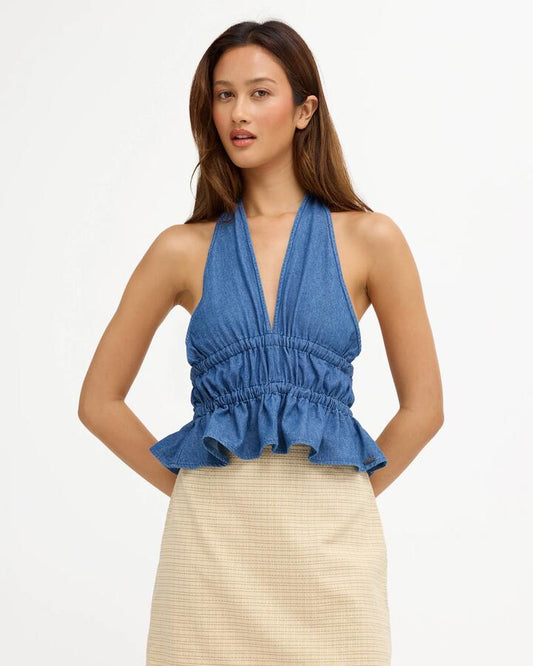 Image of a model wearing Tops. Product name - Volcom Womens Ambient Halter Top Denim in Denim colour by brand - Volcom
