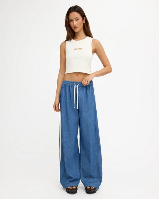 Image of a model wearing Pants. Product name - Volcom Womens Zephyr Pants Denim in Denim colour by brand - Volcom