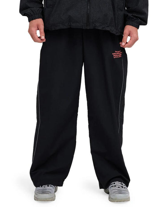 Image of a model wearing Pants. Product name - Quiksilver Mens Stab Spray Tracksuit Pants Black in Black colour by brand - Quiksilver
