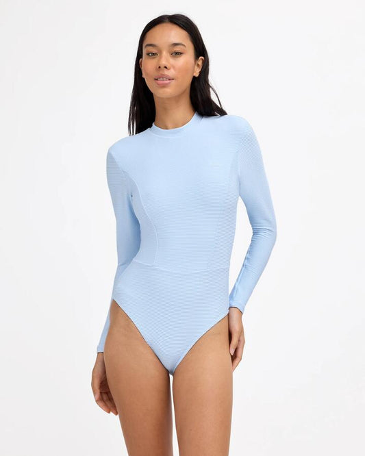 Image of a model wearing Tops. Product name - Billabong Womens Tanlines Long Sleeve Bodysuit Rash Vest Cool Blue in Cool Blue colour by brand - Billabong