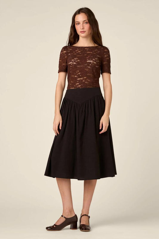 Image of a model wearing Skirts. Product name - Nell V-Yoke Midi Skirt in Black colour by brand - Princess Highway