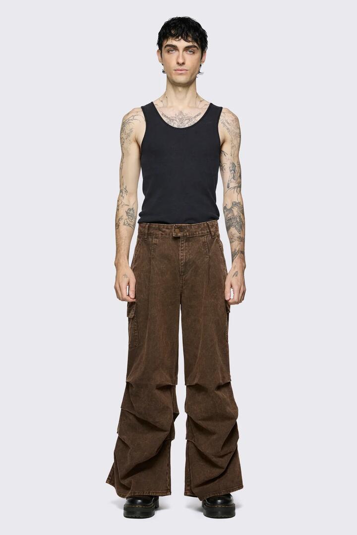 Image of a model wearing Pants. Product name - Behind The Blinds Baggy Cargo in Brown colour by brand - Black Friday