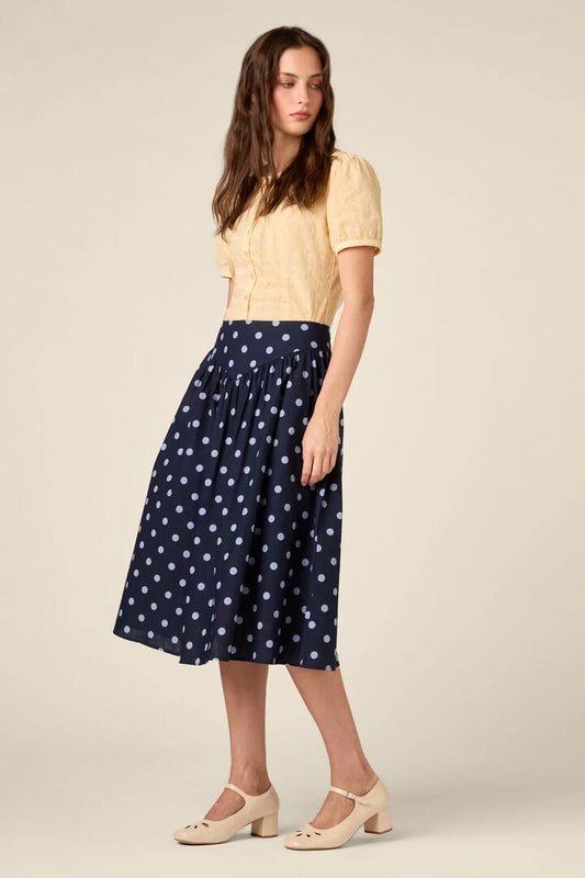 Image of a model wearing Skirts. Product name - Mia Polka Dot Midi Skirt in Navy colour by brand - Princess Highway