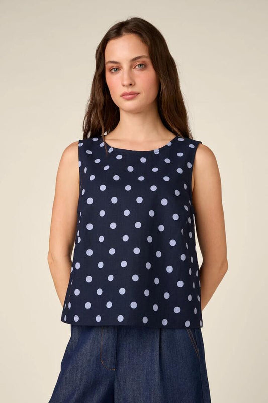 Image of a model wearing Tops. Product name - Mia Polka Dot Shell Top in Navy colour by brand - Princess Highway