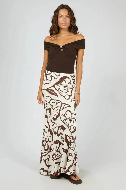 Image of a model wearing Skirts. Product name - Lucia Vintage White Choc Floral Print Maxi Skirt in Brown colour by brand - Silent Theory