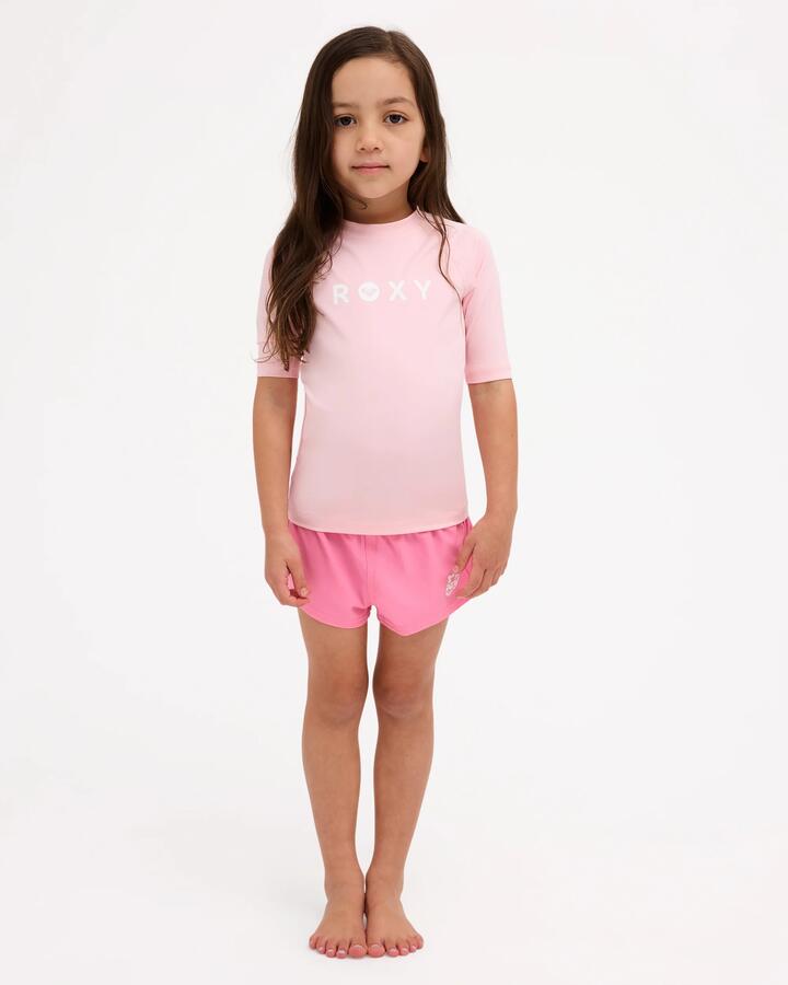Image of a model wearing Tops. Product name - Roxy Girls 2-7 Essential Short Sleeve Rash Vest Rose Shadow in Rose Shadow colour by brand - Roxy