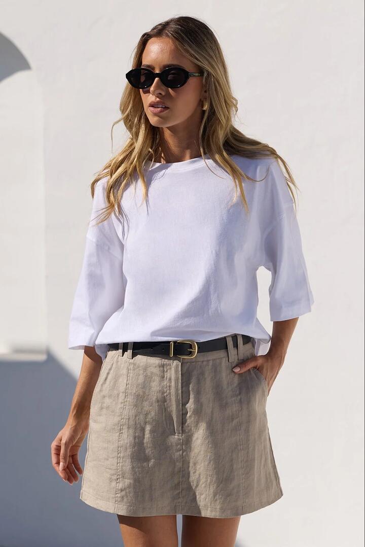 Image of a model wearing Skirts. Product name - Alignment Stone Linen Mini Skort in Stone colour by brand - RE:UNION Label